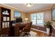 Home office with dark wood desk, book shelves, and large window with ample natural light at 3333 Melbourne S Rd, Indianapolis, IN 46228