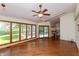 Bright sunroom with hardwood floors and panoramic views of the backyard at 3333 Melbourne S Rd, Indianapolis, IN 46228