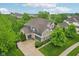 Aerial view of a two-story home featuring a basketball court, lush landscaping, and a well-manicured lawn at 3744 Abney Point Dr, Carmel, IN 46077