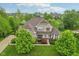 Aerial view of a beautiful home with mature trees and landscaping at 3744 Abney Point Dr, Carmel, IN 46077