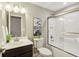 Bathroom with vanity, stylish mirror, modern lighting, and a shower with sliding glass door at 3744 Abney Point Dr, Carmel, IN 46077