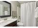 Cozy bathroom with a tub and shower combination, dark vanity, and decorative mirror at 3744 Abney Point Dr, Carmel, IN 46077