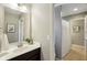 Bathroom featuring a vanity with white countertop, a dark cabinet, and a shower with a white curtain at 3744 Abney Point Dr, Carmel, IN 46077