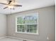 Bright bedroom featuring a ceiling fan and a large window providing ample natural light at 3744 Abney Point Dr, Carmel, IN 46077