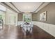 Elegant dining room with coffered ceilings, modern chandelier, and views of the landscaped yard at 3744 Abney Point Dr, Carmel, IN 46077
