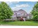 Charming two-story home featuring stone and siding exterior with manicured lawn and lush landscaping at 3744 Abney Point Dr, Carmel, IN 46077