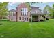 Expansive backyard featuring a well-maintained lawn, patio area, and a partial view of the home's brick exterior at 3744 Abney Point Dr, Carmel, IN 46077