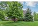Well-maintained lawn with mature trees and landscaping surrounding a beautiful two-story home at 3744 Abney Point Dr, Carmel, IN 46077