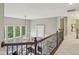 Upstairs hallway with decorative wood railing overlooks a spacious living room and fireplace at 3744 Abney Point Dr, Carmel, IN 46077