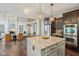 Kitchen featuring a granite island and stainless steel appliances with an open view of the living area at 3744 Abney Point Dr, Carmel, IN 46077