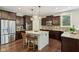 Well-equipped kitchen with stainless steel appliances, granite countertops, and dark wood cabinets at 3744 Abney Point Dr, Carmel, IN 46077