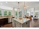 Kitchen island featuring granite countertops and an open view of the fireplace and living area at 3744 Abney Point Dr, Carmel, IN 46077