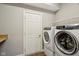 Well-lit laundry room featuring a modern washer and dryer and extra storage shelving at 3744 Abney Point Dr, Carmel, IN 46077