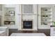 Elegant fireplace with custom built-ins and tile surround, creating a cozy focal point in the living room at 3744 Abney Point Dr, Carmel, IN 46077