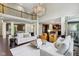 Expansive living room featuring a soaring ceiling, elegant chandelier, and open floor plan to the kitchen at 3744 Abney Point Dr, Carmel, IN 46077