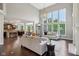 Bright and airy living room with soaring ceilings, large windows, and a stylish modern chandelier at 3744 Abney Point Dr, Carmel, IN 46077