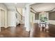 Open-concept living room flowing into the dining area, featuring hardwood floors and custom millwork at 3744 Abney Point Dr, Carmel, IN 46077