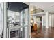 Spacious and well-lit living area showcases elegant fireplace and custom built-ins viewed from residential elevator at 3744 Abney Point Dr, Carmel, IN 46077
