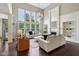 Spacious living room with large windows, fireplace, custom built-ins and elegant decor at 3744 Abney Point Dr, Carmel, IN 46077