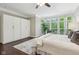 Bright bedroom featuring a large bay window and custom wardrobe at 3744 Abney Point Dr, Carmel, IN 46077
