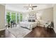 Spacious bedroom with large windows, ceiling fan, and hardwood floors at 3744 Abney Point Dr, Carmel, IN 46077