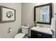 Stylish powder room featuring a dark vanity and modern fixtures at 3744 Abney Point Dr, Carmel, IN 46077