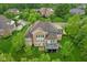 Stately home boasts a deck perfect for outdoor relaxation and entertaining, set against a backdrop of lush green landscaping at 3744 Abney Point Dr, Carmel, IN 46077