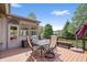 Back deck area featuring outdoor dining set and enclosed sunroom overlooking the yard at 3823 Brigade Cir, Carmel, IN 46032