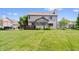 Expansive backyard view of a home featuring a wooden deck and well-maintained lawn at 3823 Brigade Cir, Carmel, IN 46032