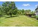 Expansive backyard with well-manicured lawn, mature trees, and a deck area at 3823 Brigade Cir, Carmel, IN 46032