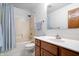 Bathroom with a wood vanity, shower, and well-lit mirror at 3823 Brigade Cir, Carmel, IN 46032