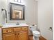 Half bathroom featuring a wood vanity with sink and a toilet at 3823 Brigade Cir, Carmel, IN 46032