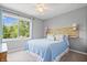Comfortable bedroom featuring a large window with a view of the surrounding trees at 3823 Brigade Cir, Carmel, IN 46032