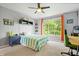 Nicely decorated bedroom with window, desk, and ceiling fan at 3823 Brigade Cir, Carmel, IN 46032