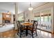 Dining area with wood table and chairs, sliding doors to patio, and view of living room at 3823 Brigade Cir, Carmel, IN 46032