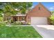 Charming brick home with a two-car garage, manicured lawn, and landscaped front yard at 3823 Brigade Cir, Carmel, IN 46032