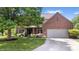 Inviting brick home with attached garage, lush lawn, and mature tree offering curb appeal at 3823 Brigade Cir, Carmel, IN 46032