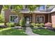 Close-up of the front of a brick home, featuring a landscaped yard and charming entrance at 3823 Brigade Cir, Carmel, IN 46032