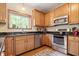 Well-lit kitchen features stainless steel appliances and wood cabinets at 3823 Brigade Cir, Carmel, IN 46032