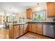 Charming kitchen with stainless appliances, granite countertops, wood cabinets and adjacent dining area at 3823 Brigade Cir, Carmel, IN 46032