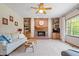 Cozy living room with brick fireplace, built-in bookshelves, and large window at 3823 Brigade Cir, Carmel, IN 46032