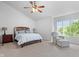 Spacious main bedroom with vaulted ceiling, ceiling fan, and sitting area at 3823 Brigade Cir, Carmel, IN 46032