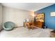 Home office space with neutral and blue accent walls, desk, and comfortable seating at 3823 Brigade Cir, Carmel, IN 46032