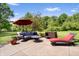 Inviting patio with comfortable seating, an umbrella, and lush greenery surrounding the space at 3823 Brigade Cir, Carmel, IN 46032