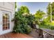 Charming backyard with a brick patio, mature trees, and a view of the house with classic architecture at 3840 N Washington Blvd, Indianapolis, IN 46205