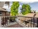 View from a balcony overlooking a well-manicured backyard with mature trees at 3840 N Washington Blvd, Indianapolis, IN 46205