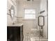Stylish bathroom featuring black and white tiles, a glass shower, and modern fixtures at 3840 N Washington Blvd, Indianapolis, IN 46205