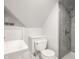 Cozy bathroom under sloped ceilings, including a toilet, sink and shower at 3840 N Washington Blvd, Indianapolis, IN 46205