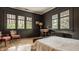 Comfortable bedroom with hardwood floors, windows and stylish furnishings at 3840 N Washington Blvd, Indianapolis, IN 46205