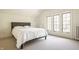 Bedroom featuring neutral carpet, a comfortable bed, and natural light through large windows at 3840 N Washington Blvd, Indianapolis, IN 46205